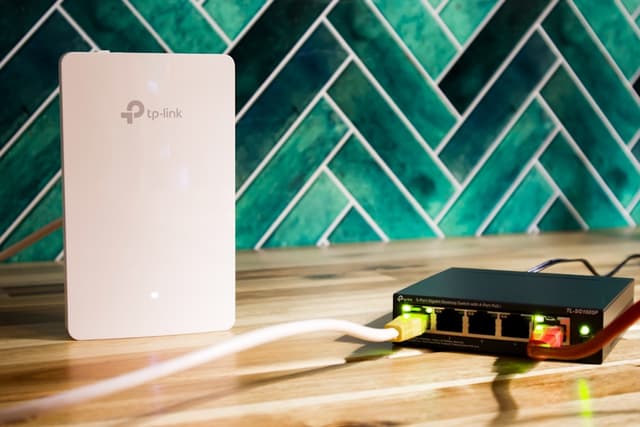 Wi-Fi router beside a network switch